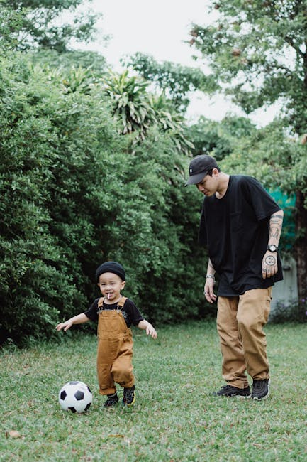 Father bonding with son over a soccer game in the lush backyard, representing family fun and happiness.